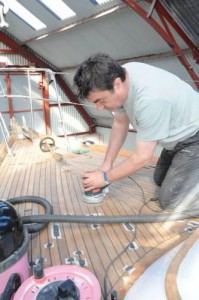 Barry Lovell sanding a teak deck